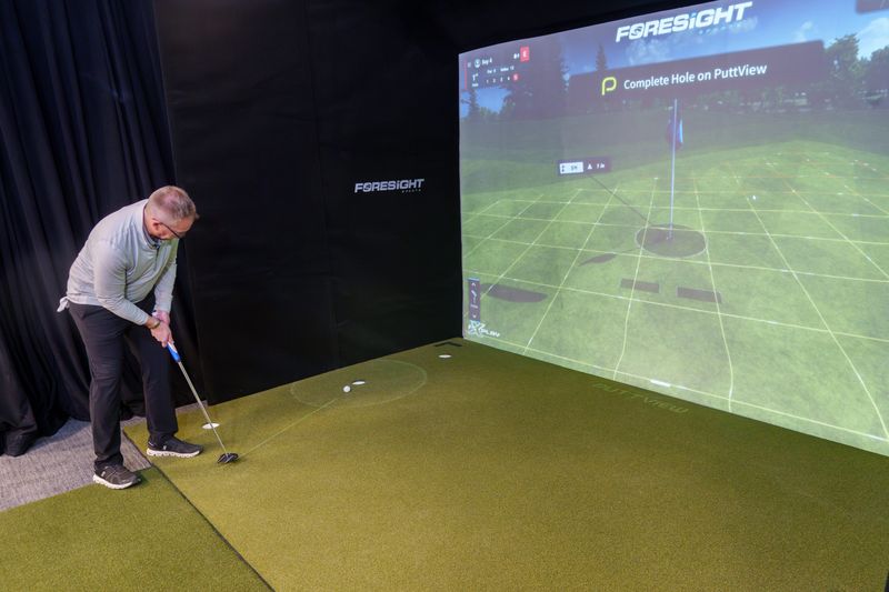 Illini Golf owner Matt Coulter tests his putting skills on a state-of-the-art golf simulator that not only gives accurate readings on drives, but also calculates and displays the best path for a putt. Illini Golf is expanding and moving into the former Bushwhacker building in the Metro Centre.