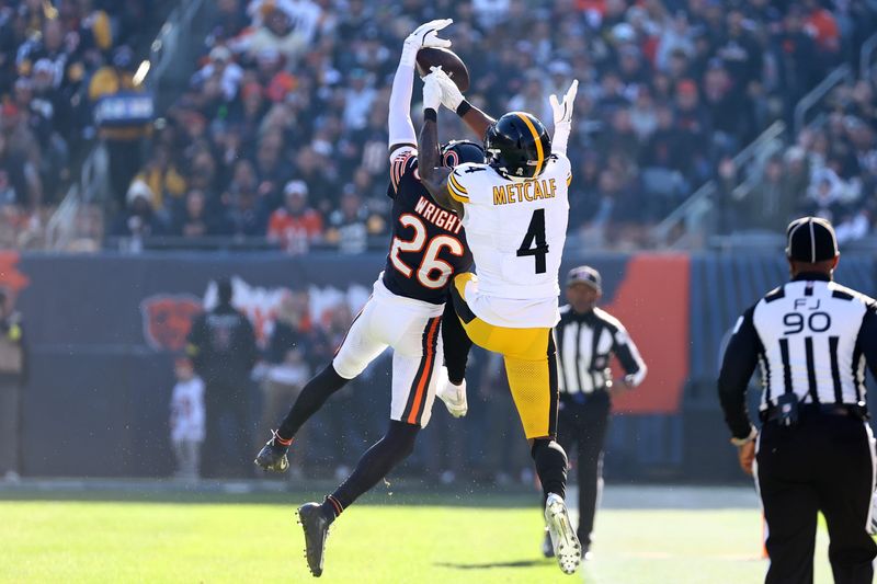 Nov 23, 2025; Chicago, Illinois, USA; Chicago Bears cornerback Nahshon Wright (26) intercepts a pass against Pittsburgh Steelers wide receiver DK Metcalf (4) during the first half at Soldier Field. Mandatory Credit: Mike Dinovo-Imagn Images