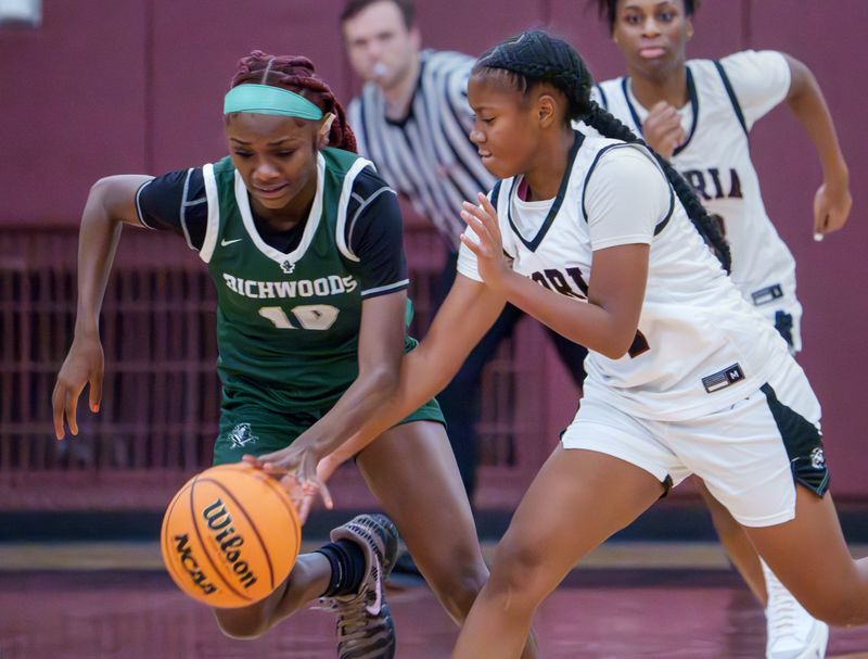 Peoria High’s Meriah Avant, right, tries to knock the ball away from Richwoods’ Keniya Todd in the first half of their high school basketball game Tuesday, Dec. 2, 2025 at Peoria High School. The Knights defeated the Lions 66-39.