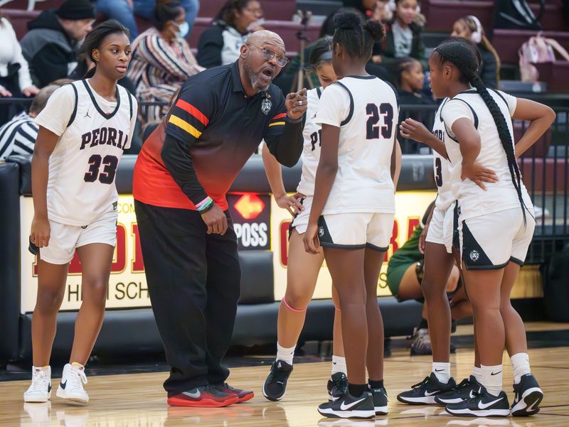 Peoria High head coach Meechie Edwards directs his team as they battle Richwoods in the first half of their high school basketball game Tuesday, Dec. 2, 2025 at Peoria High School. The Knights defeated the Lions 66-39.