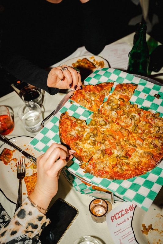 Customers can find thin-crust pizza at Pizz’Amici. The Chicago eatery was named on Esquire’s 2025 list of Best New Restaurants in America.