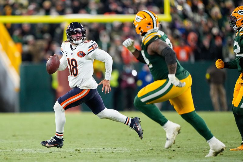 Dec 7, 2025; Green Bay, Wisconsin, USA; Chicago Bears quarterback Caleb Williams (18) scrambles out of the pocket in the third quarter against the Green Bay Packers at Lambeau Field. Mandatory Credit: Jeff Hanisch-Imagn Images