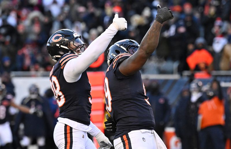 Dec 14, 2025; Chicago, Illinois, USA; Chicago Bears defensive end Montez Sweat (98) and Chicago Bears defensive tackle Gervon Dexter Sr. (99) celebrate after a sack of Cleveland Browns quarterback Shedeur Sanders (12) during the fourth quarter at Soldier Field. Mandatory Credit: Matt Marton-Imagn Images