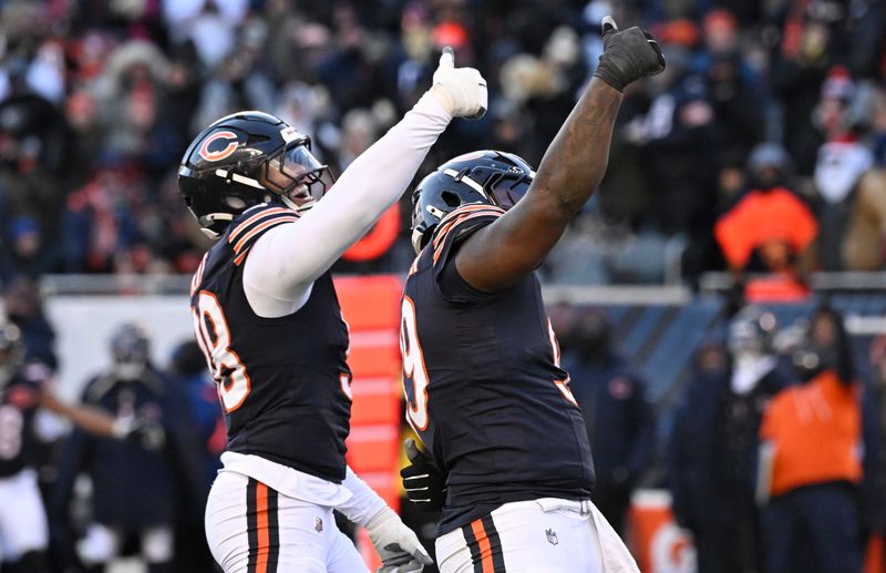 Dec 14, 2025; Chicago, Illinois, USA; Chicago Bears defensive end Montez Sweat (98) and Chicago Bears defensive tackle Gervon Dexter Sr. (99) celebrate after a sack of Cleveland Browns quarterback Shedeur Sanders (12) during the fourth quarter at Soldier Field. Mandatory Credit: Matt Marton-Imagn Images