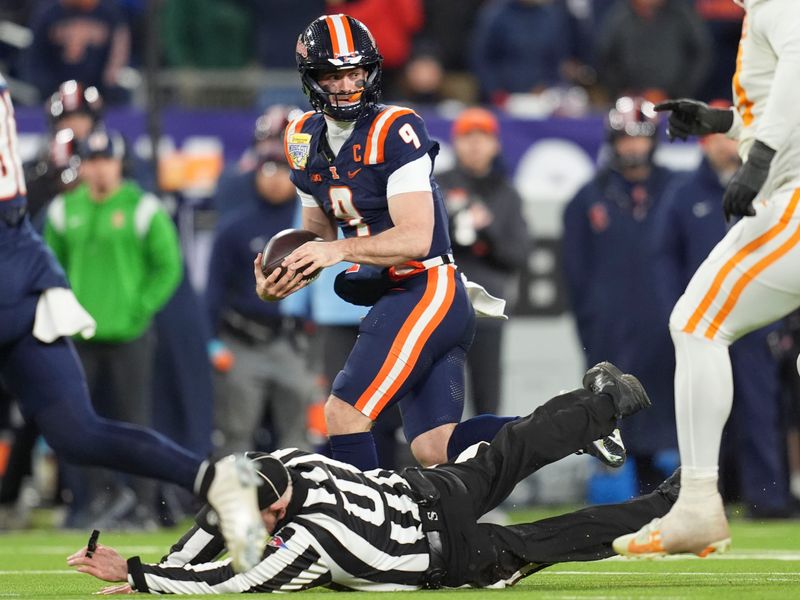 Illinois quarterback Luke Altmyer (9) collides with an official during the Music City Bowl NCAA college football game against Tennessee on Dec. 30, 2025, in Nashville, Tennessee.
