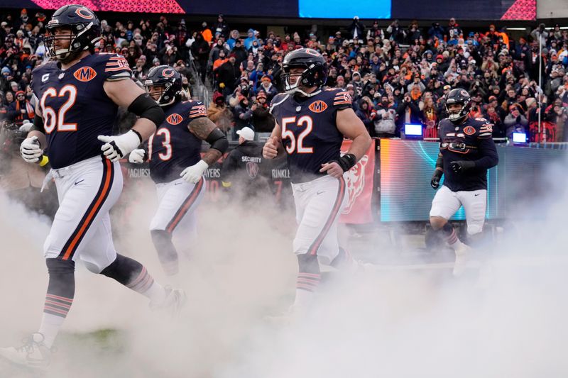 Jan 4, 2026; Chicago, Illinois, USA; Chicago Bears guard Joe Thuney (62) and center Drew Dalman (52) run onto the field before the game between the Chicago Bears and the Detroit Lions at Soldier Field. Mandatory Credit: David Banks-Imagn Images