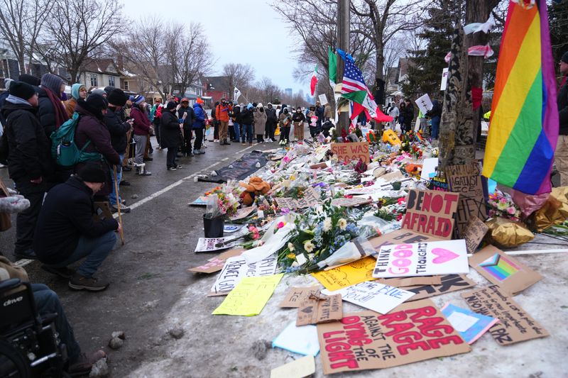 People gather at a makeshift memorial for Renee Nicole Good in Minneapolis on January 10, 2026. Good, 37, was shot and killed on Wednesday by Jonathan Ross, an Immigration and Customs Enforcement removal officer based in Minnesota. The shooting happened amid an immigration enforcement action.