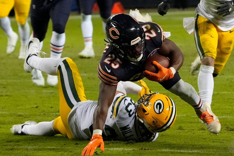 Jan 10, 2026; Chicago, IL, USA; Chicago Bears running back Kyle Monangai (25) runs after the catch for a first down as Green Bay Packers safety Evan Williams (33) defends during the second half of an NFC Wild Card Round game at Soldier Field. Mandatory Credit: David Banks-Imagn Images