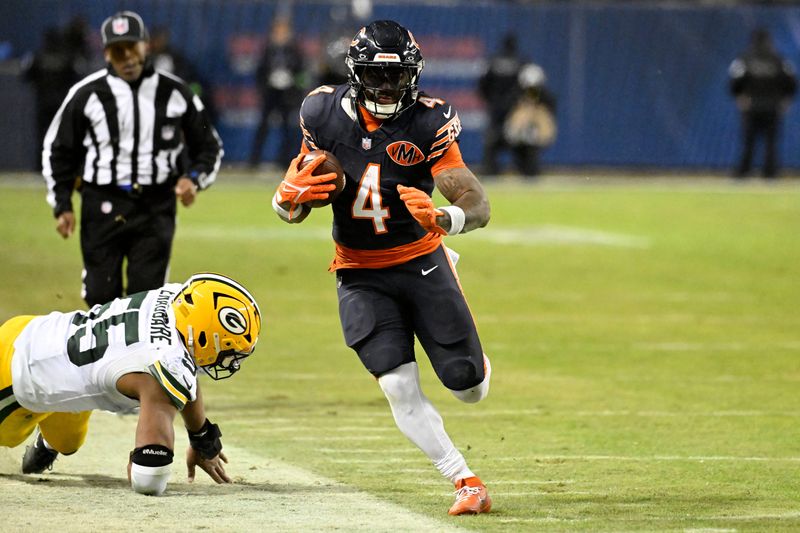Jan 10, 2026; Chicago, IL, USA; Chicago Bears running back D'Andre Swift (4) runs runs after the catch as Green Bay Packers defensive end Kingsley Enagbare (55) defends during the second half of an NFC Wild Card Round game at Soldier Field. Mandatory Credit: Matt Marton-Imagn Images