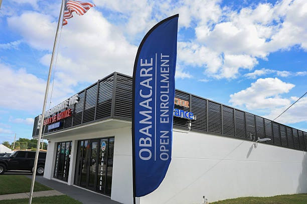 MIAMI, FLORIDA - NOVEMBER 12: An Obamacare sign sits in front of an insurance agency on November 12, 2025 in Miami, Florida. (Photo by Joe Raedle/Getty Images)