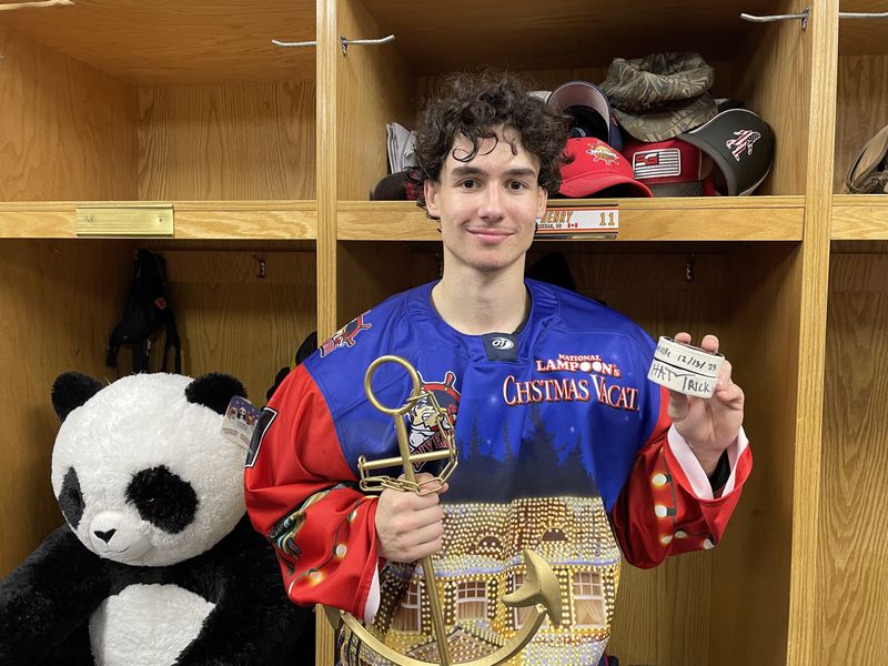 Peoria Rivermen winger Khaden Henry holds pucks from his hat trick and the team's boat anchor player award after leading the SPHL leaders to a victory in a Dec. 13, 2025 SPHL game at Carver Arena.
