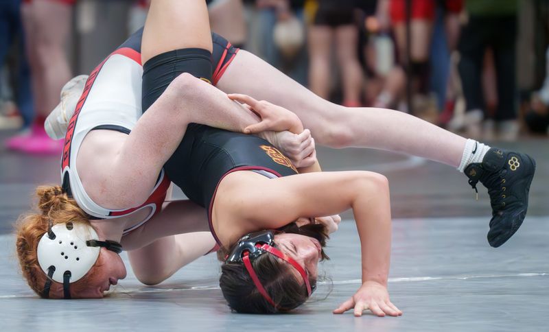 Metamora's Calliope Willman, left, and Morris' Zara Lugo get upside down during the 125-pound quarterfinal match of the girls wrestling regionals Saturday, Feb. 7, 2026 at Normal West High School. Lugo won with a 6-5 decision.