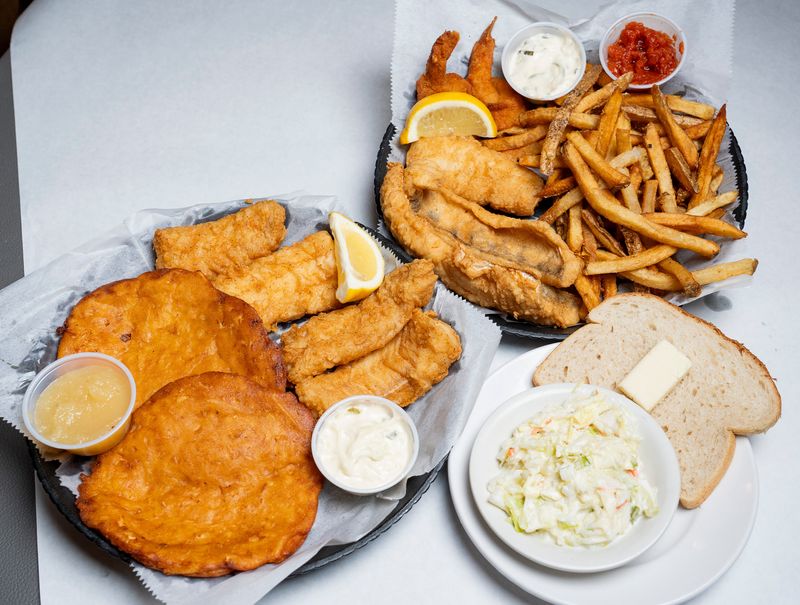 On the Clock Bar & Grill offers a fish fry meal (left) with 12 ounces of fried cod and potato pancakes, and a seafood combo (right) with perch, walleye, cod, two shrimp, hand-cut french fries and cocktail sauce. Both are served with house-made coleslaw, rye bread and tartar sauce, all pictured on Feb. 6, 2026.