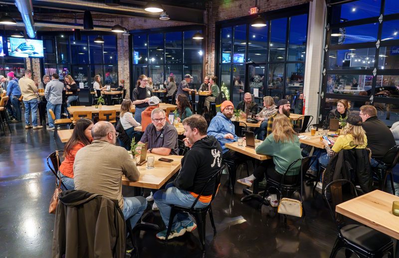 Patrons enjoy the new pub Analytical Brewing during a soft opening at 831 SW Adams Street in Peoria’s Warehouse District. The new spot is the second location for the successful Lexington-based brewery.