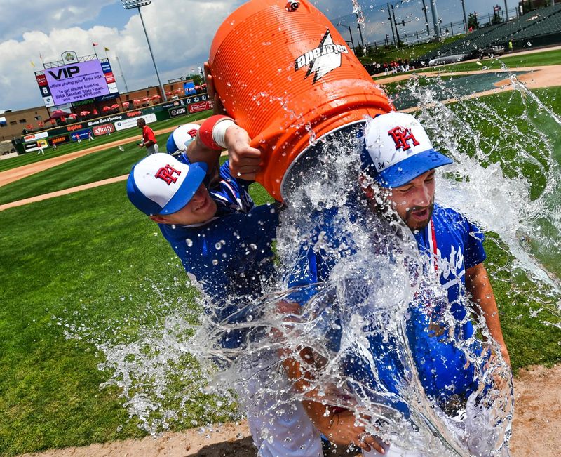Peoria Heights head coach Matt King is doused with water after winning the 2017 IHSA Class 1A state baseball championship at Dozer Park.