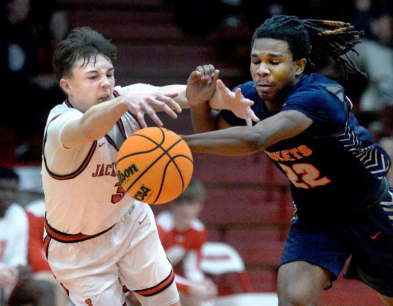Jacksonville's Harrison Alexander, left, and Rochester's Khorbin Gregory scramble for a lose ball during the game Friday, Feb. 13, 2026.