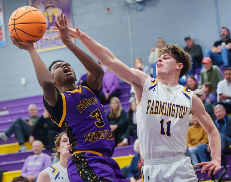Peoria Christian's Jacob Walton, left, puts up a shot past Farmington's Blake Melz in the second half of their high school basketball game Friday, Feb. 13, 2026 in Farmington. The Farmers defeated the Chargers 75-65.