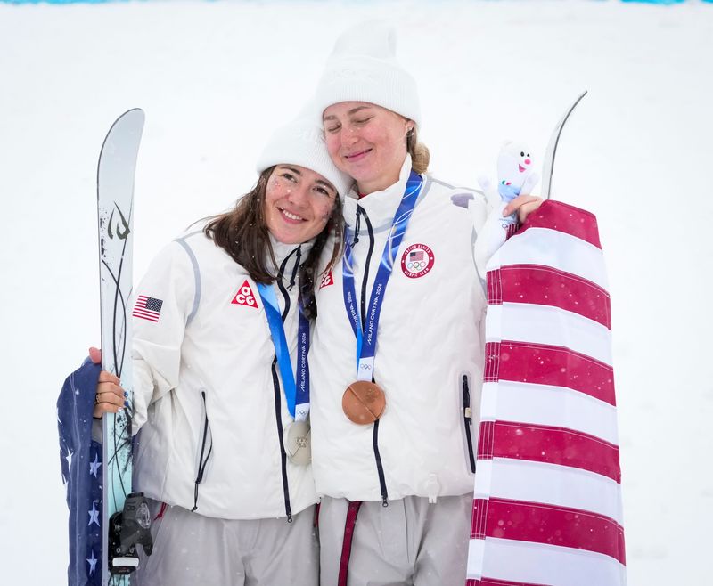Team USA bronze medalist Elizabeth Lemley, right, and silver medalist Jaelin Kauf of the United States celebrate during the medal ceremony for women's dual moguls on Feb. 14 at the 2026 Winter Olympics.