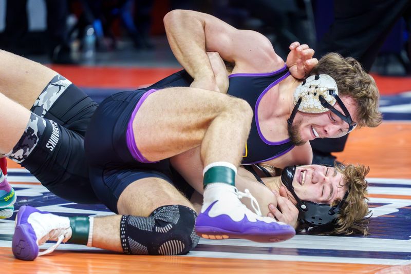 Hononegah's Brody Sendele, top, tries to pin Aurora West's Dayne Serio in the 175-pound title match of the Class 3A state wrestling championship Saturday, Feb. 21, 2026 at the State Farm Center in Champaign. Sendele took the title with a fall.