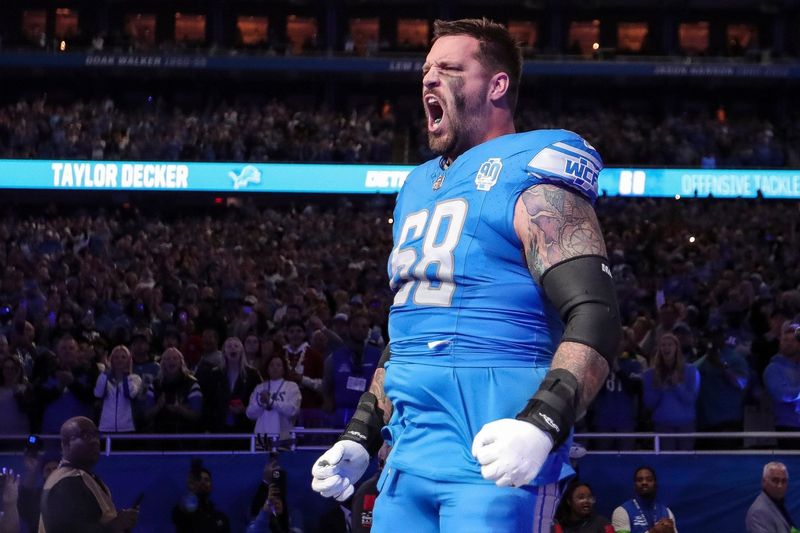 Detroit Lions left tackle Taylor Decker takes the field during player introductions before the Detroit Lions game against the Carolina Panthers at Ford Field in Detroit on Sunday, Oct. 8, 2023.