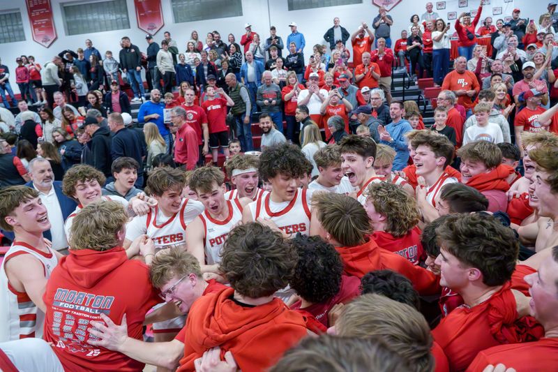 Morton fans mob the Potters after their win over Metamora in the Class 3A boys basketball regional title game Friday, Feb. 27, 2026 in Morton. The Potters advanced to the Ottawa Sectional with a 55-42 victory.