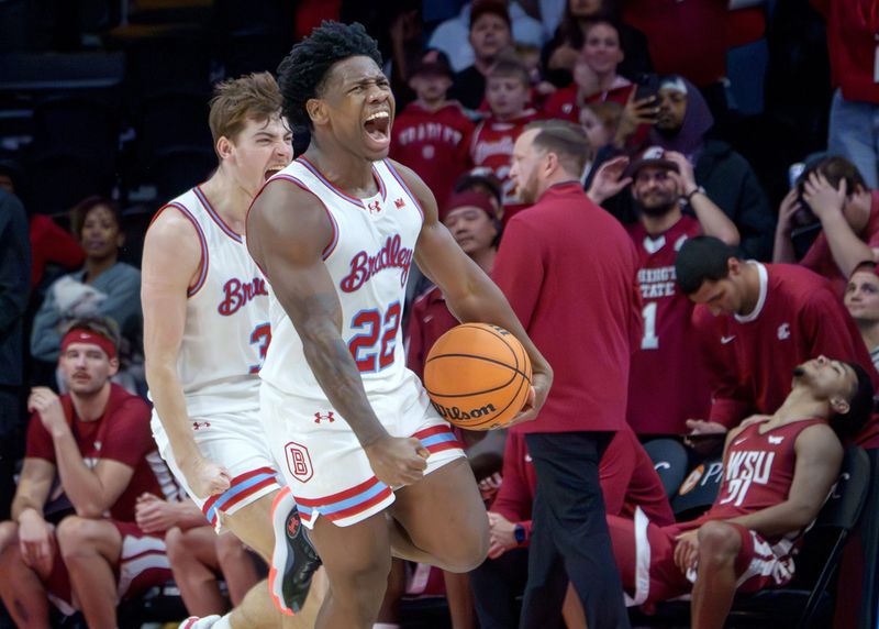Bradley's Jaquan Johnson, foreground and Alex Huibregtse celebrate the Braves' 64-60 comeback win over Washington State on Tuesday, Dec. 2, 2025 at Carver Arena in Peoria.