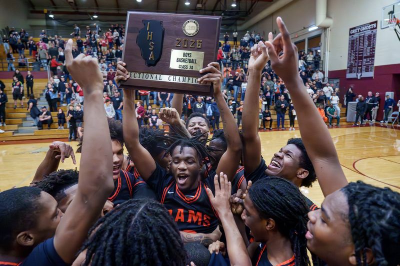 The Manual Rams celebrate their Class 2A boys high school basketball sectional championship after defeating Warsaw West Hancock 57-41 on Friday, March 6, 2026 at IVC High School in Chillicothe.
