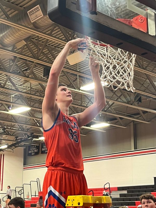 Eastland's Parker Krogman cuts down the nets at Orion after Eastland won the IHSA Class 1A boys sectional title on March 6, 2026 at Orion High School vs. Pecatonica.