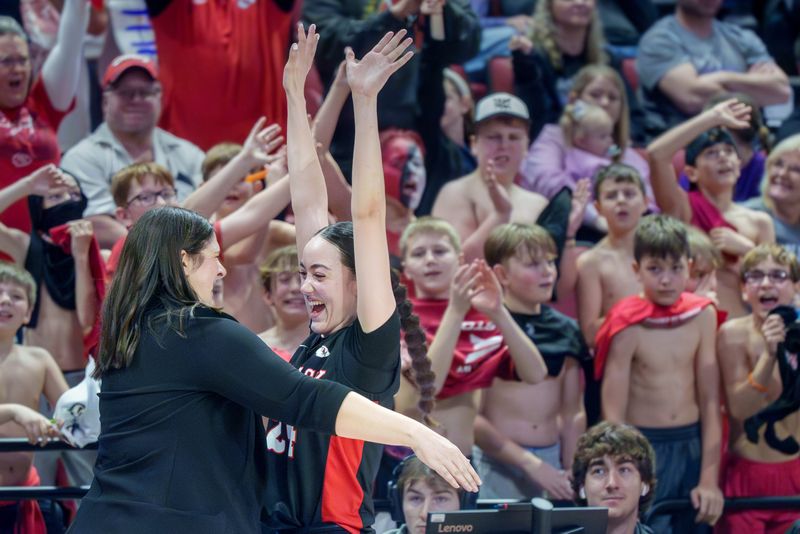 Dee-Mack's Dalia Dejesus, right, goes in for a hug from head coach Joni Nightingale as time winds down on the Chiefs' 49-34 win over Mt. Pulaski for the IHSA Class 1A girls high school state basketball title Friday, March 7, 2026 at CEFCU Arena in Normal.