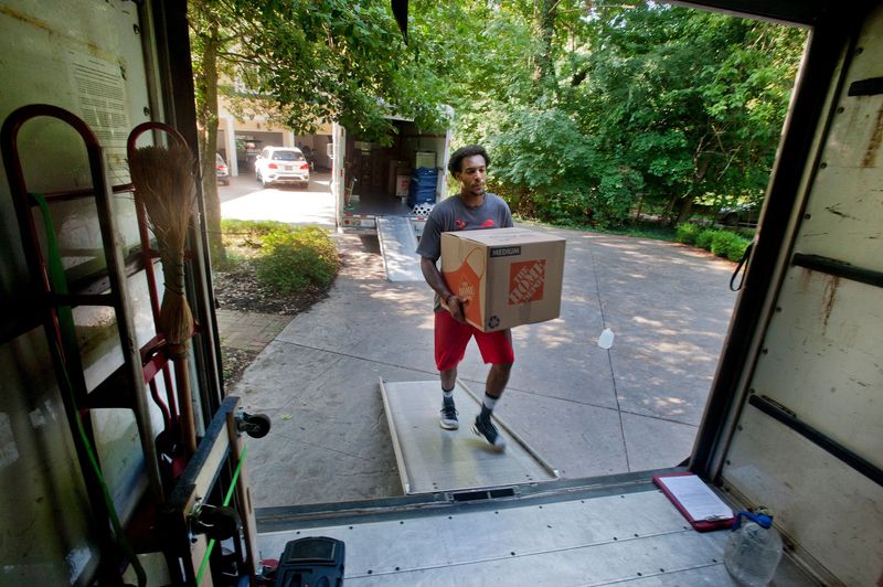 Titus Phillips of Cardinal Moving carries a box onto the moving truck at the home of John and Camilla Schroeder to the truck. The Schroeders are moving from their Holly Lane home in Anchorage.
July 11, 2018

0711anchoragemove003 Drl