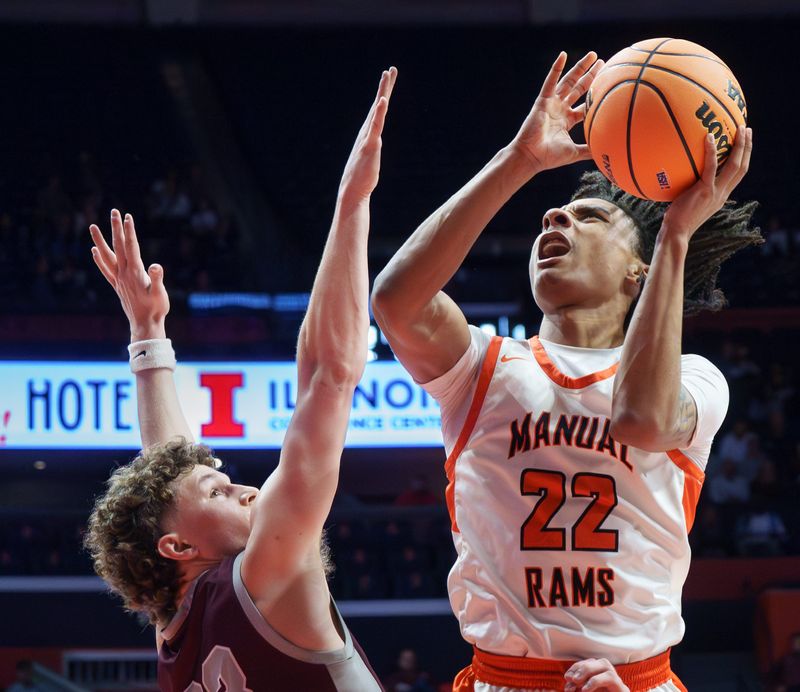 Manual’s Josh Humbles, right, goes to the basket against Tolono Unity’s Dane Eisenmenger in the second half of their Class 2A boys high school basketball state semifinal Thursday, March 12, 2026 at the State Farm Center in Champaign. The Rams advanced to the title game with a 62-57 win.