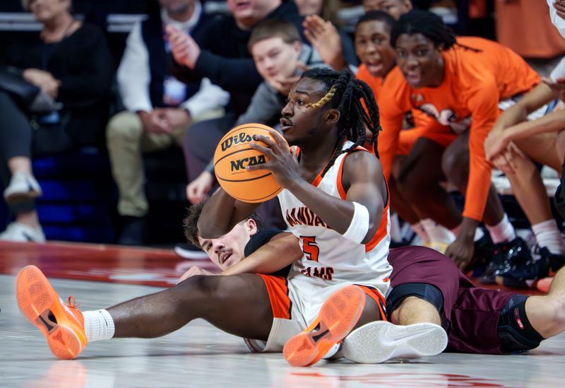 Manual’s Reggie Postlewaite looks for a teammate to pass to after recovering a loose ball over Tolono Unity in the first half of their Class 2A boys high school basketball state semifinal Thursday, March 12, 2026 at the State Farm Center in Champaign. The Rams advanced to the title game with a 62-57 win.