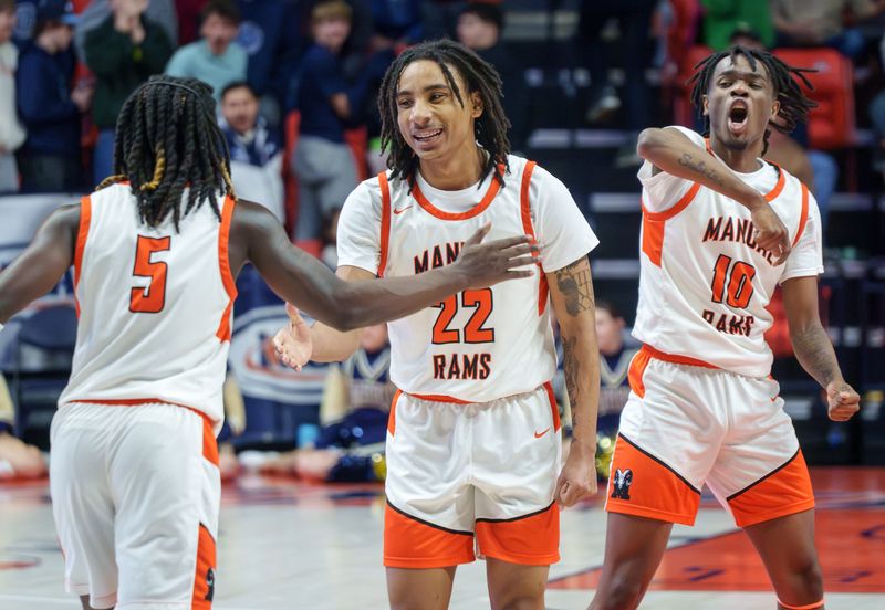 Manual's Reggie Postlewaite (5), Josh Humbles (22) and Jaquan Brown celebrate as time runs out on their 60-55 win over Quincy Notre Dame in the Class 2A boys high school state basketball championship game Saturday, March 14, 2026, at the State Farrm Center in Champaign.