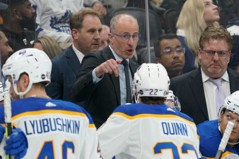 Buffalo Sabres head coach and former Peoria Rivermen head coach Don Granato talks to his team during the third period against the Toronto Maple Leafs at Scotiabank Arena in 2023. At far right is Buffalo assistant and former Rivermen head coach Jason Christie.