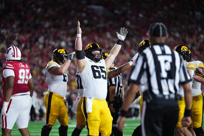 Oct 11, 2025; Madison, Wisconsin, USA; Iowa Hawkeyes offensive lineman Logan Jones (65) celebrates a touchdown in the first half against the Wisconsin Badgers at Camp Randall Stadium. Mandatory Credit: Ross Harried-Imagn Images
