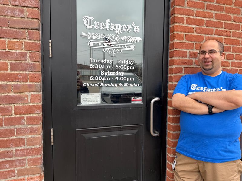 Peoria Heights' Armando Flores stands outside Trefzger's Bakery where he began working after 19 years of working at the village's Save-a-Lot grocery store. The grocery store closed its doors in March of this year.
