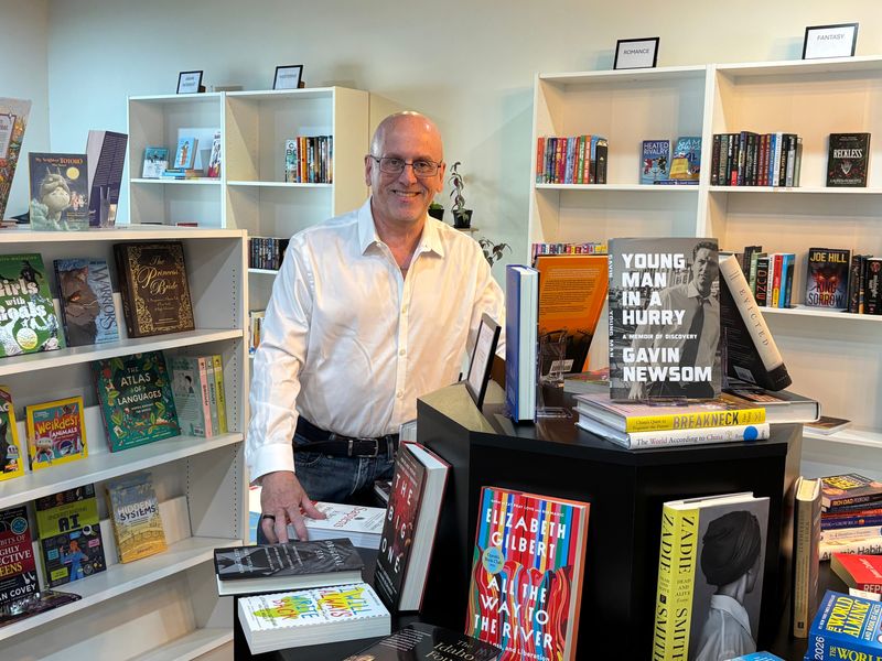 River City Reading Room owner Chuck Levesque displays some of the downtown Peoria bookstore's inventory.