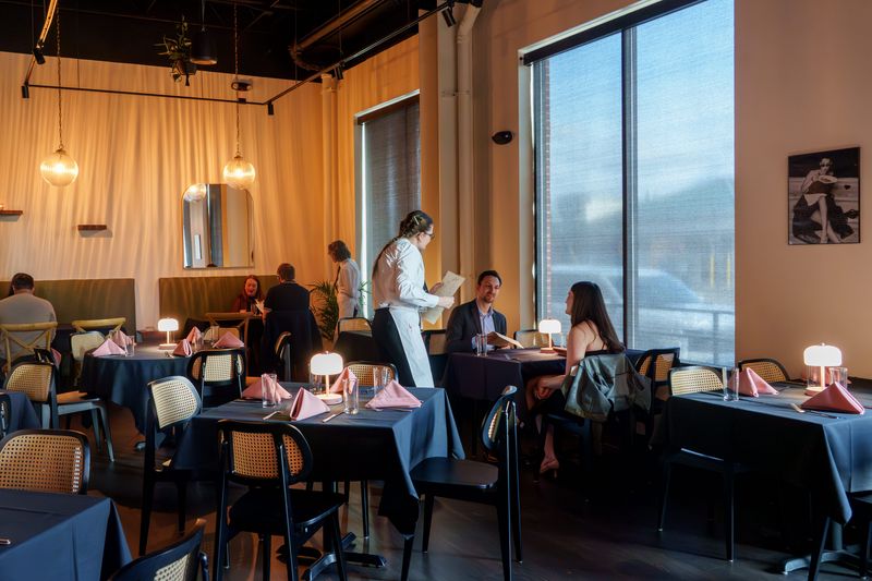 Diners order their food during a soft opening dinner at the new Peoria Heights restaurant Sloane Supper & Social at 4500 N. Prospect Road.