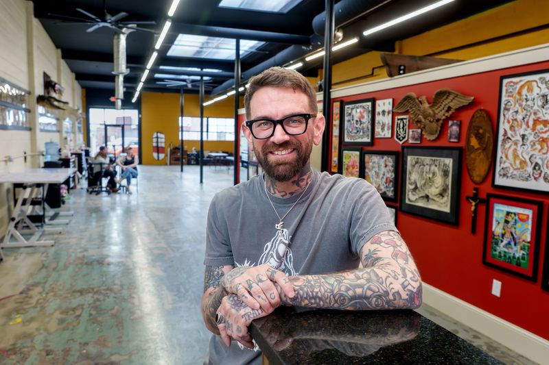 Veteran tattoo artist Zach Dole poses in his new studio Brass Eagle Tattoo in a former printing business at 718 SW Adams Street in Peoria’s Warehouse District. Dole opened his shop in early April after a long tenure at Freedom Ink Tattoos in Downtown Peoria.