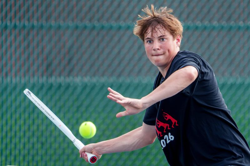 Metamora’s Tommy Sopko eyes a return against Pekin’s Cooper Behrends in a Mid-Illini dual tennis match Tuesday, April 14, 2026, in Metamora.