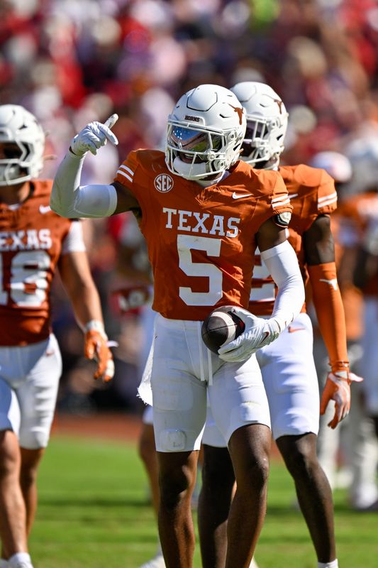 Oct 11, 2025; Dallas, Texas, USA; Texas Longhorns defensive back Malik Muhammad (5) celebrates after an interception during the game between the Texas Longhorns and the Oklahoma Sooners at the Cotton Bowl. Mandatory Credit: Jerome Miron-Imagn Images