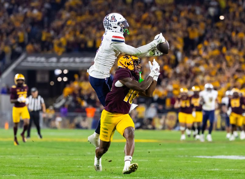 Nov 28, 2025; Tempe, Arizona, USA; Arizona Wildcats defensive back Treydan Stukes (2) intercepts the ball against Arizona State Sun Devils wide receiver Jaren Hamilton (16) in the second half during the 99th Territorial Cup at Mountain America Stadium. Mandatory Credit: Mark J. Rebilas-Imagn Images