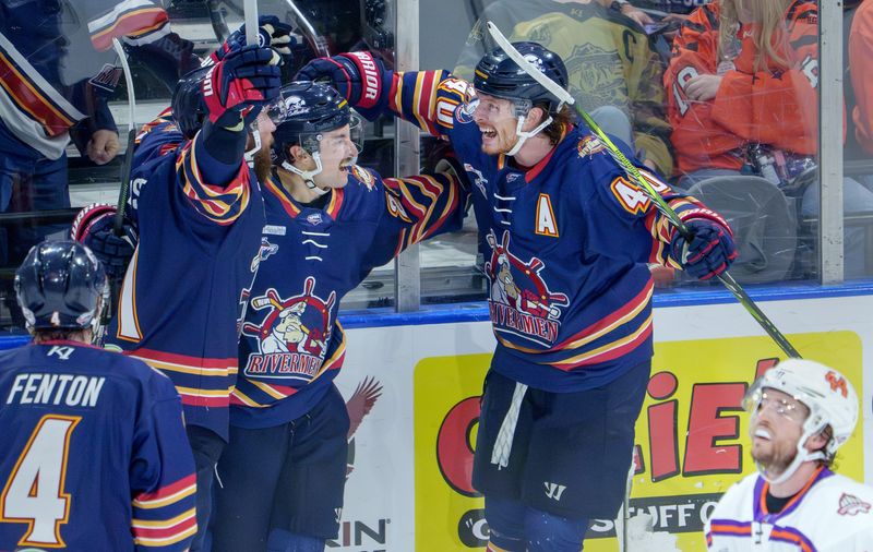 Peoria Rivermen teammates JM Piotrowski, right, and Jordan Ernst, left, celebrate a tie-breaking goal by Connor Szmul, middle, in the third period of Game 1 of the SPHL semifinals Friday, April 17, 2026 at Carver Arena. The goal proved to be the game-winner as the Rivermen went on to defeat the Knoxville Ice Bears 6-3.
