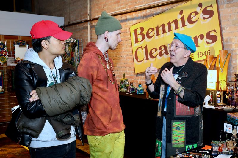 Rockford artist Norm Knott, right, speaks with guests April 22, 2023, during Spring ArtScene at Bennie’s Cleaners in downtown Rockford.
