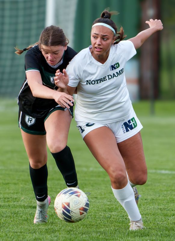 Peoria Notre Dame’s Ava Lafollette, right, and Richwoods’ Maddie McCarthy battle for the ball in the first half of their high school girls soccer match Tuesday, April 21, 2026 at Richwoods High School. The Irish defeated the Knights 7-0.