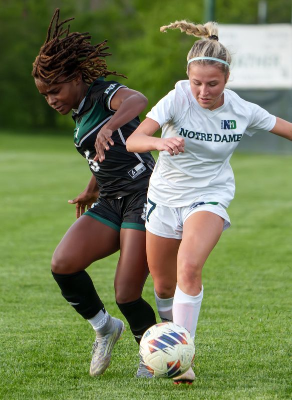 Richwoods’ Acosia Morris, left, and Peoria Notre Dame’s Peyton Lefler chase down the ball in the first half of their high school girls soccer match Tuesday, April 21, 2026 at Richwoods High School. The Irish defeated the Knights 7-0.