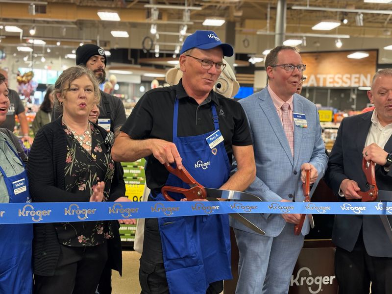 Tony Bennett (center) helps cut the ribbon to mark the Kroger's completion of a $2.2 million remodeling project for its Pekin store. Bennett has been working at the store for 46 years, making him its longest-tenured employee.