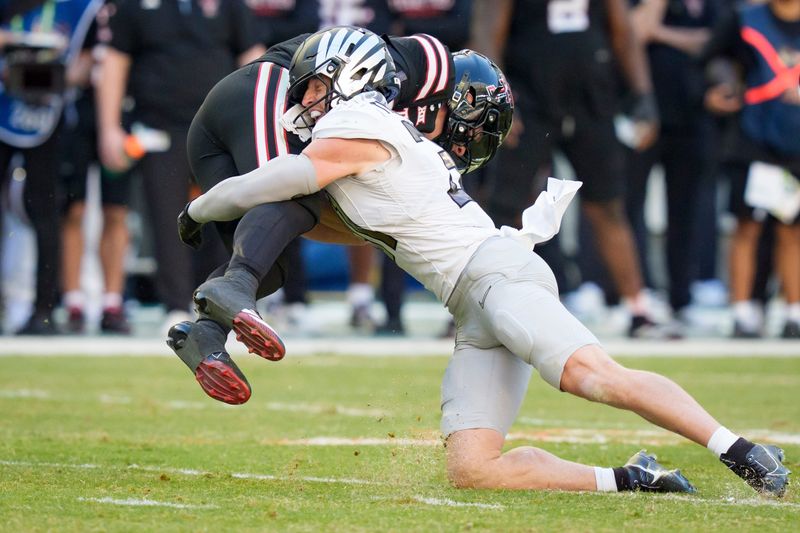 Oregon defensive back Dillon Thieneman, right, brings down Texas Tech quarterback Behren Morton as the Oregon Ducks take on the Texas Tech Red Raiders in the Orange Bowl on Jan. 1, 2026, at Hard Rock Stadium in Miami, Florida.