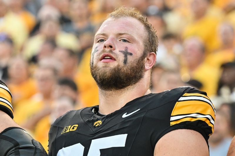 Sep 13, 2025; Iowa City, Iowa, USA; Iowa Hawkeyes offensive lineman Logan Jones (65) looks on before the game against the Massachusetts Minutemen at Kinnick Stadium. Mandatory Credit: Jeffrey Becker-Imagn Images