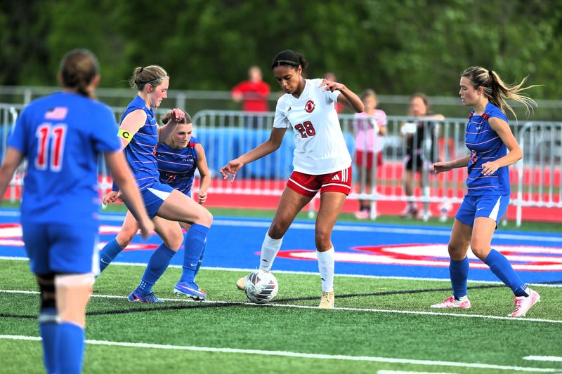 Springfield High's Kamryn Hoffman is surrounded by a host of Pleasant Plains defenders in a nonconference girls soccer game on Friday, April 24, 2026.